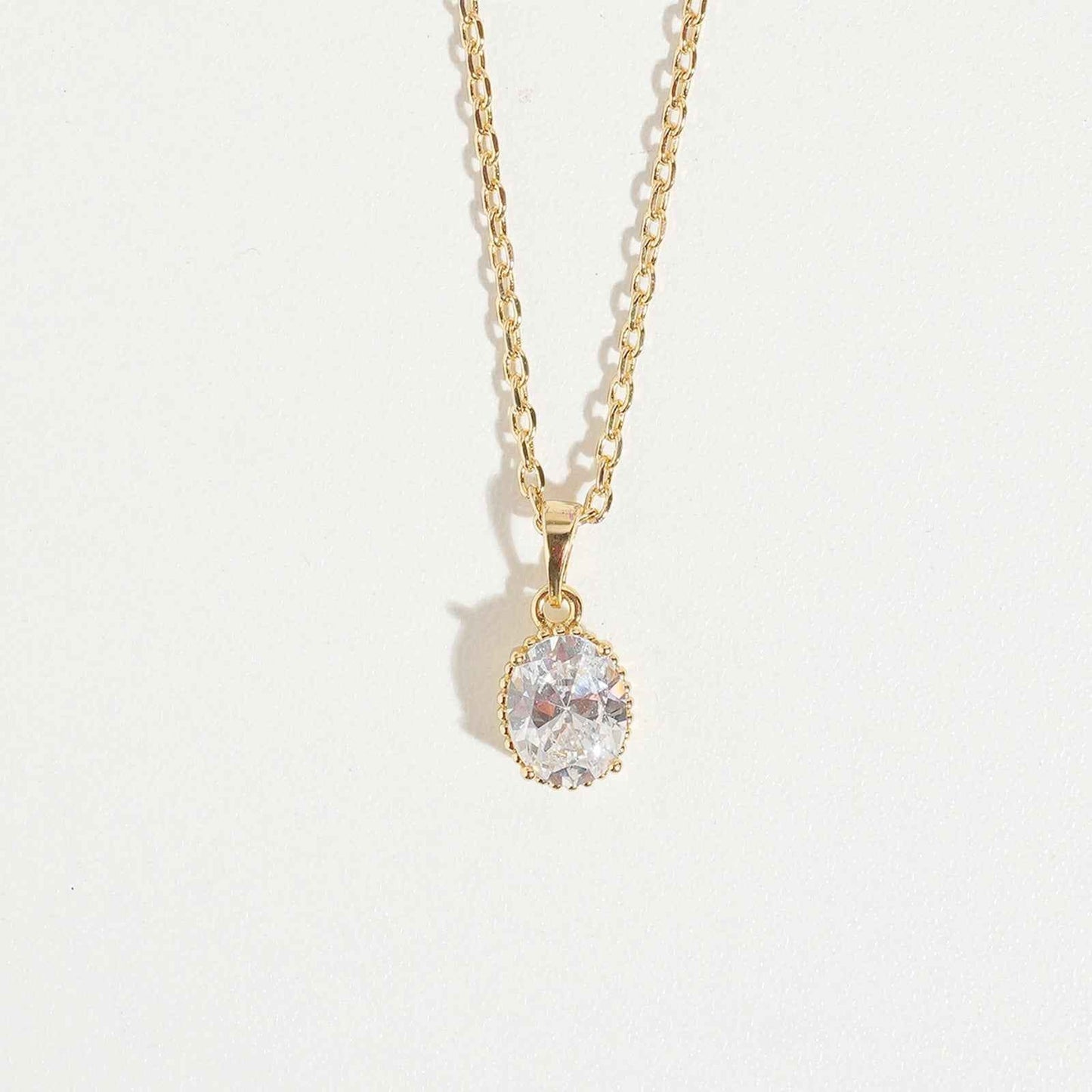 Oval Cut Necklace by Magnus, women’s pendant necklace with oval clear stone look, gold-tone chain, elegant zircon necklace style in Pakistan