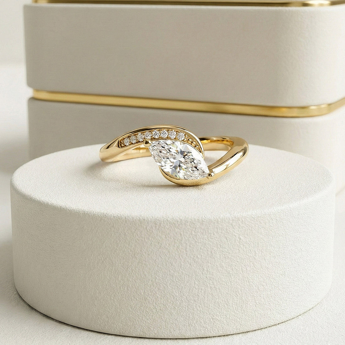 Gold ring with a diamond on a white stand
