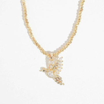 Trendy gold-tone pendant necklace with cubic zirconia and bird motif for women, perfect for special occasions and weddings.