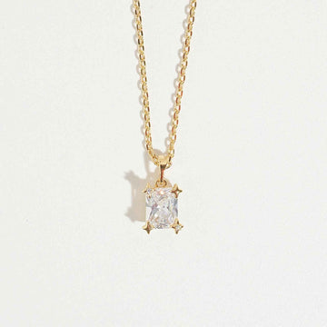 Emarald Gold Necklace by Magnus, women’s pendant necklace with rectangular clear stone look, gold-tone chain, zircon necklace style in Pakistan