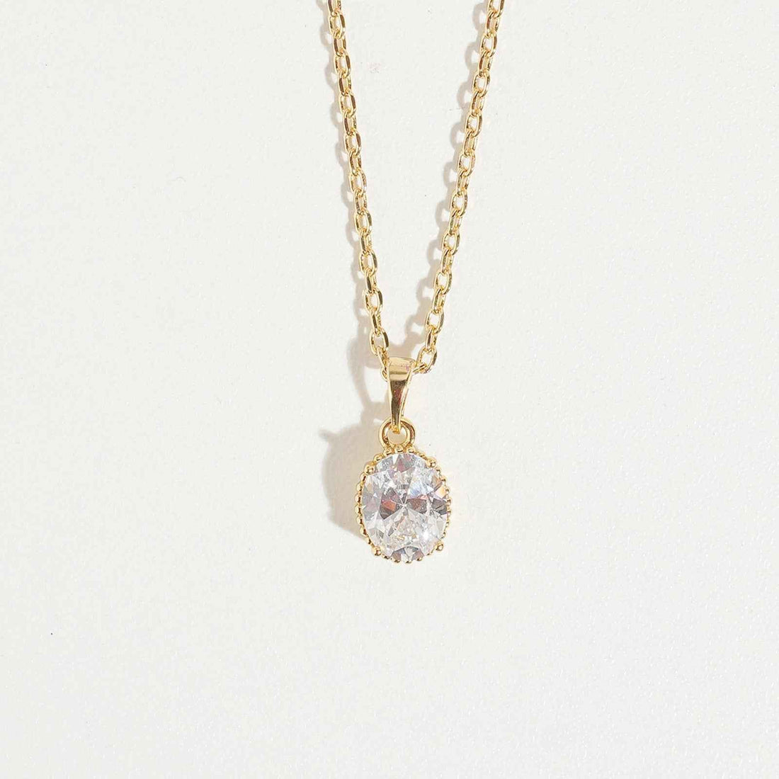 Oval Cut Necklace by Magnus, women’s pendant necklace with oval clear stone look, gold-tone chain, elegant zircon necklace style in Pakistan